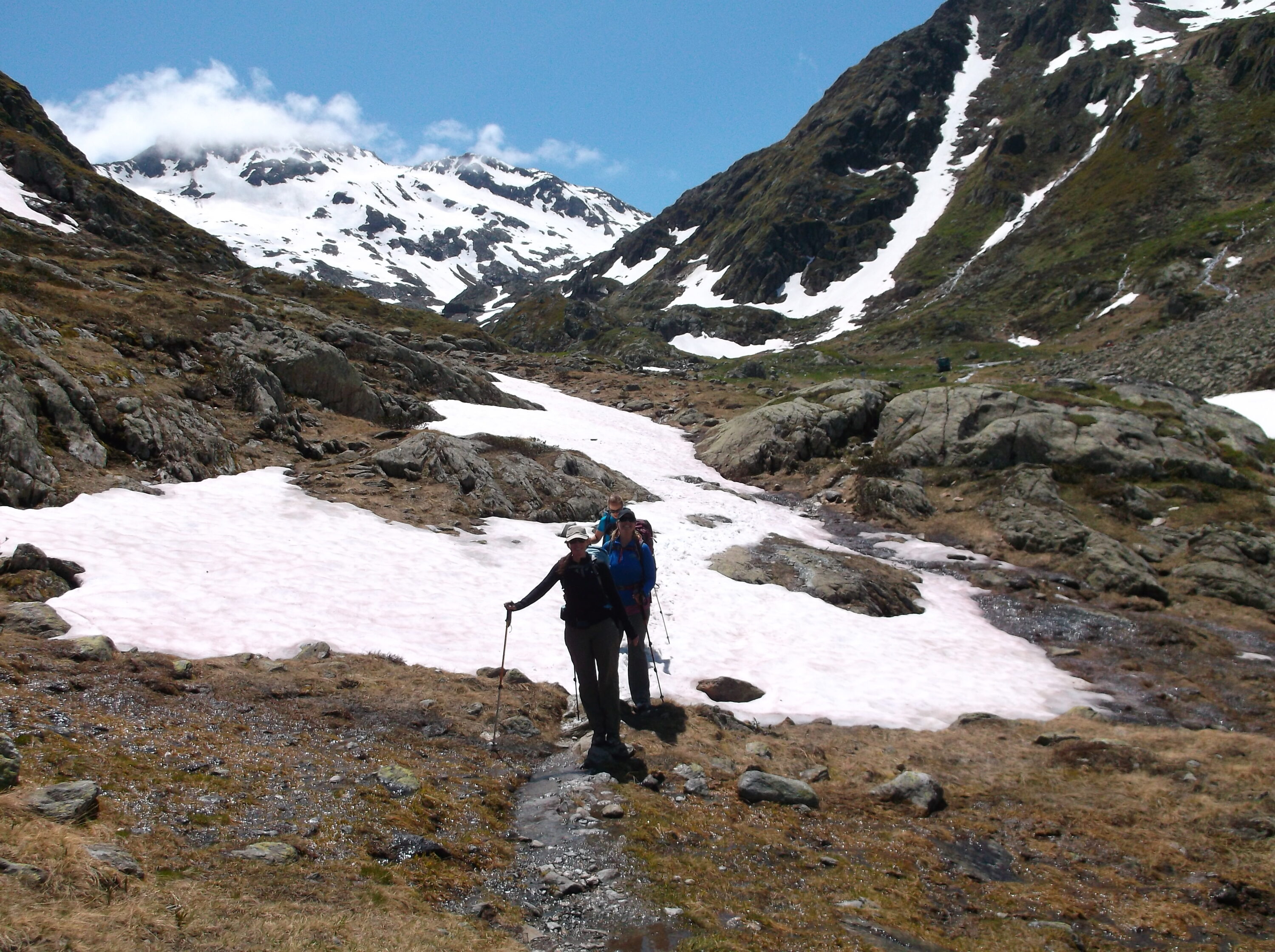 Hikers on snow covered trail in Alps